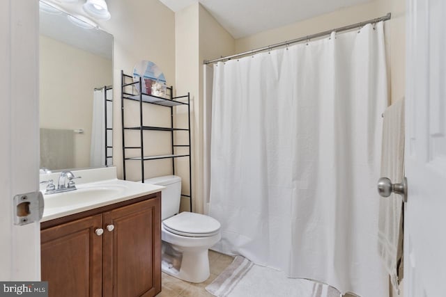 bathroom with tile patterned floors, vanity, and toilet