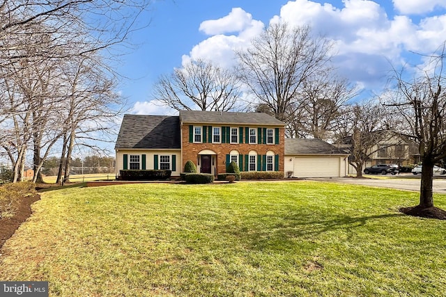 colonial home featuring a garage and a front yard