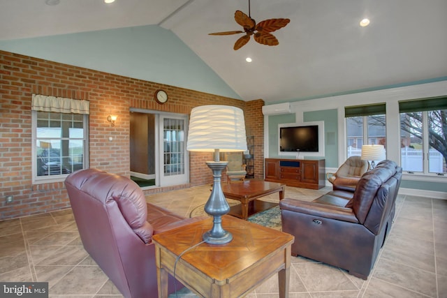 living room with ceiling fan, a healthy amount of sunlight, and brick wall