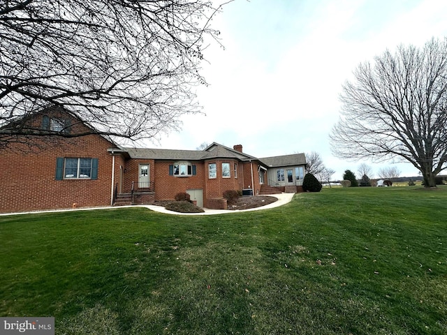 rear view of property featuring a yard