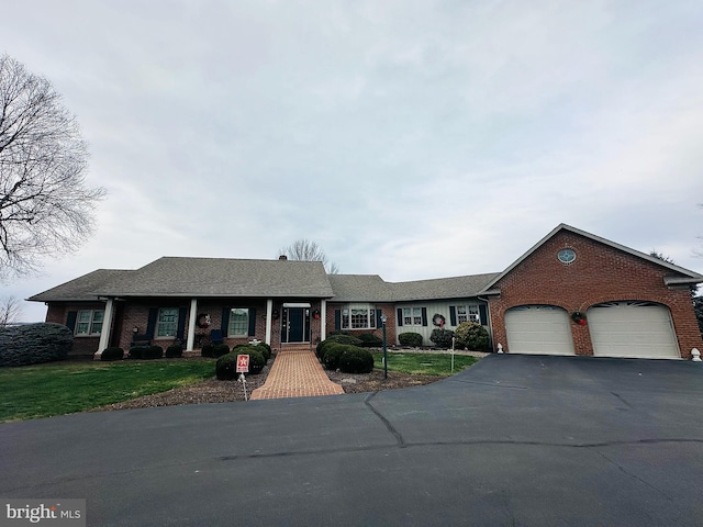 view of front of property with a front yard and a garage