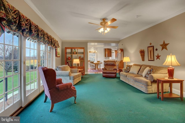 living room featuring a wealth of natural light, crown molding, carpet, and ceiling fan with notable chandelier