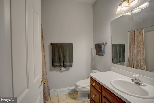 bathroom featuring curtained shower, tile patterned flooring, vanity, and toilet