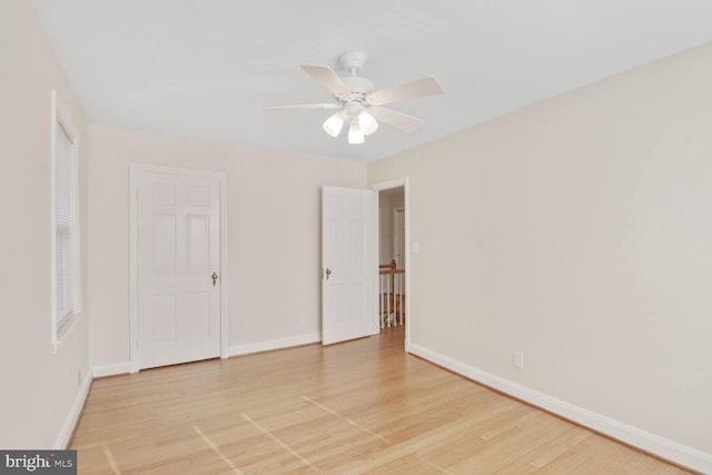 unfurnished bedroom with light wood-type flooring, baseboards, and a ceiling fan