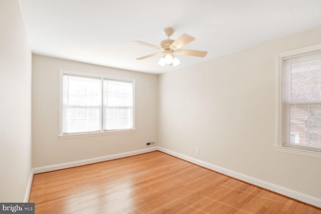 unfurnished room with visible vents, a healthy amount of sunlight, and light wood-style flooring