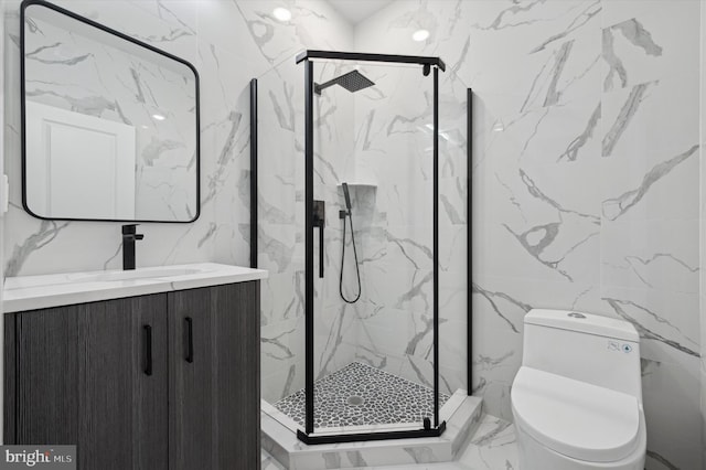 bathroom featuring a shower with door, vanity, tile walls, and toilet