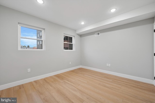 empty room with light hardwood / wood-style flooring