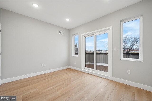 unfurnished room with light hardwood / wood-style flooring