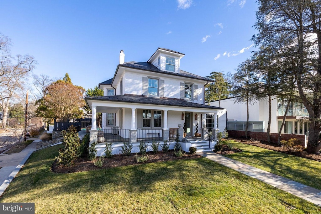 view of front of home featuring covered porch and a front yard