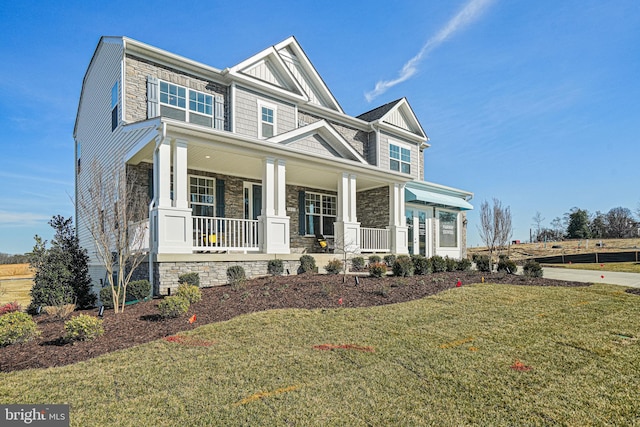 craftsman-style house with a porch and a front yard