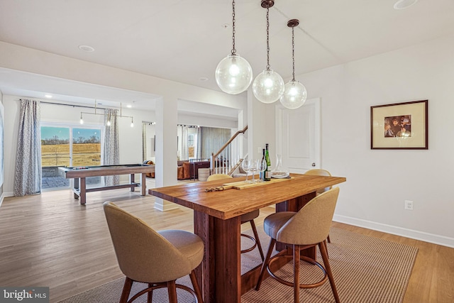 dining room with wood-type flooring and billiards