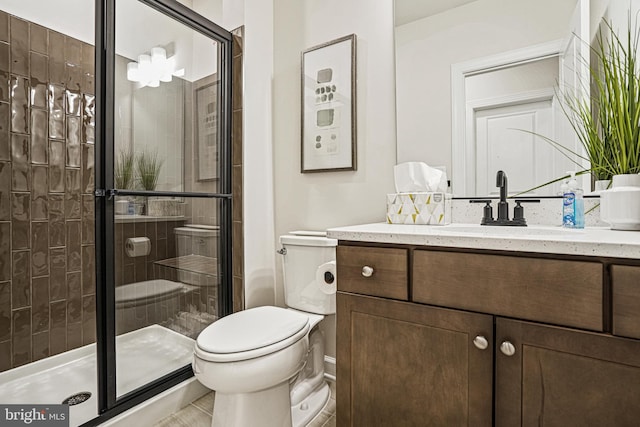 bathroom with a shower with door, vanity, and toilet