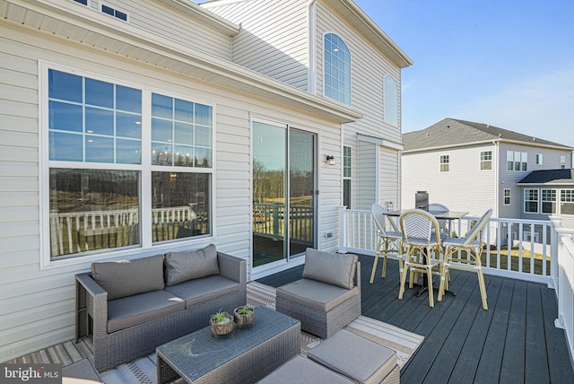 wooden terrace with an outdoor hangout area