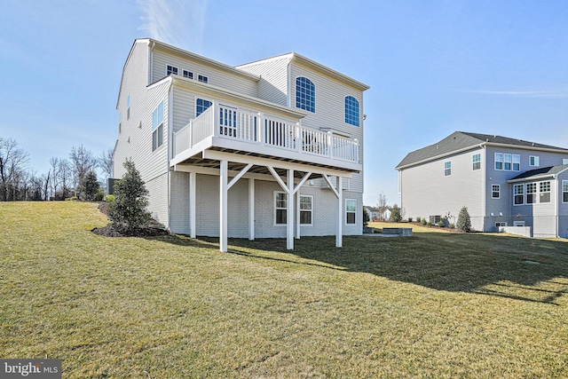 rear view of property featuring a yard and a deck