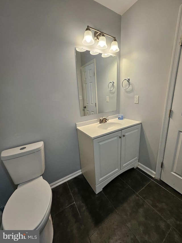 bathroom with vanity, tile patterned floors, and toilet