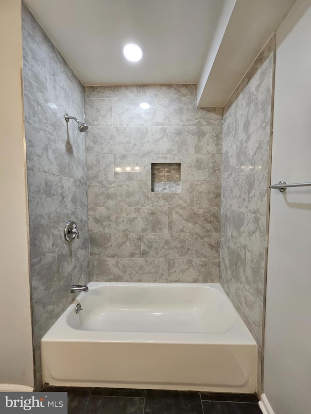 bathroom with tile patterned flooring and tiled shower / bath