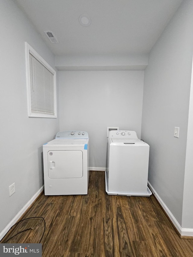 washroom featuring dark wood-type flooring and washer and dryer