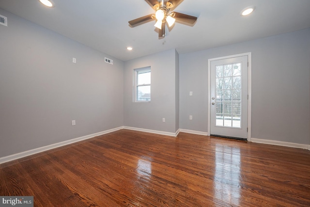 empty room featuring ceiling fan and dark wood-type flooring