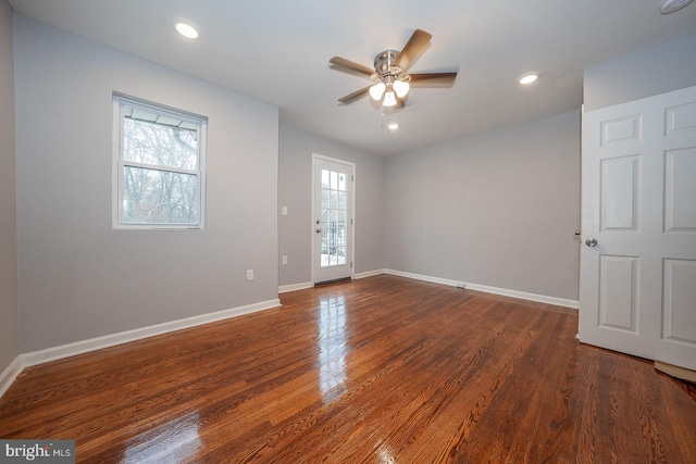 empty room featuring ceiling fan and dark wood-type flooring