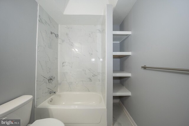 bathroom featuring toilet and tiled shower / bath