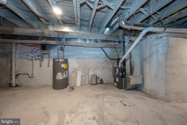 basement featuring electric water heater and heating unit