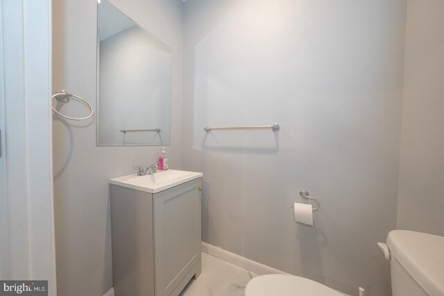 bathroom featuring vanity and toilet