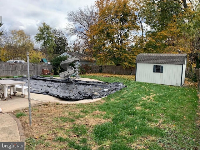 view of yard featuring a patio and a storage shed