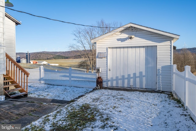 snow covered garage with a mountain view