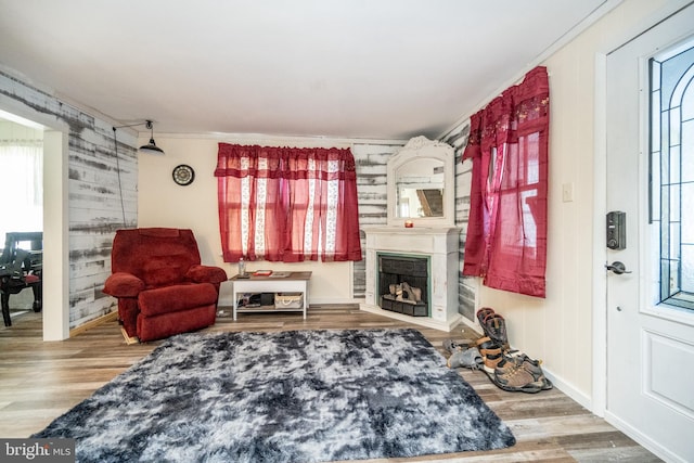 sitting room featuring plenty of natural light, wood-type flooring, and ornamental molding