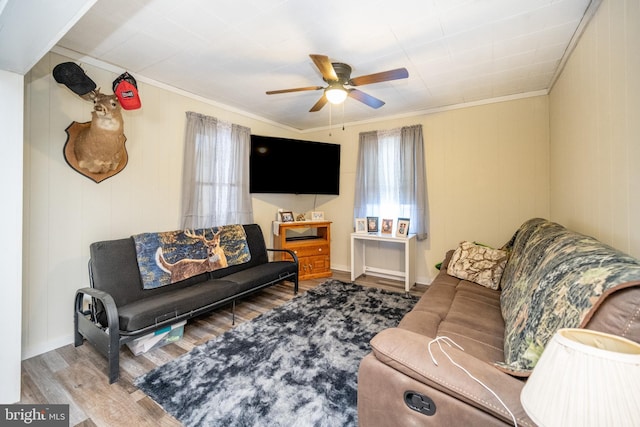 living room with ceiling fan, ornamental molding, and hardwood / wood-style flooring