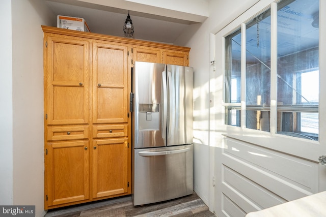 kitchen featuring stainless steel refrigerator with ice dispenser and dark wood-type flooring