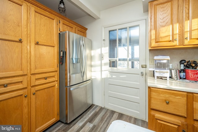 kitchen featuring stainless steel fridge with ice dispenser and dark hardwood / wood-style flooring