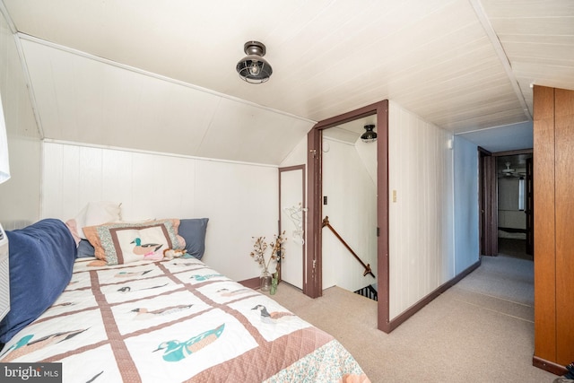 carpeted bedroom featuring vaulted ceiling and a closet