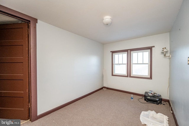 unfurnished room with light carpet