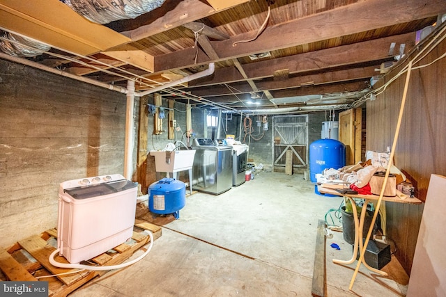 basement featuring washing machine and dryer and sink