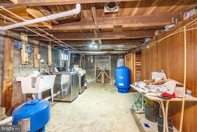 basement featuring washer and clothes dryer and sink