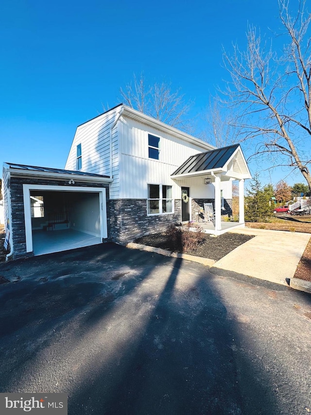 view of front of house featuring covered porch and a garage