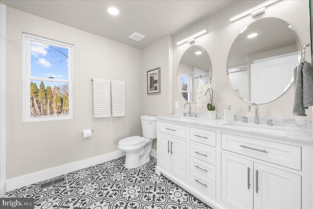 bathroom featuring tile patterned flooring, vanity, and toilet