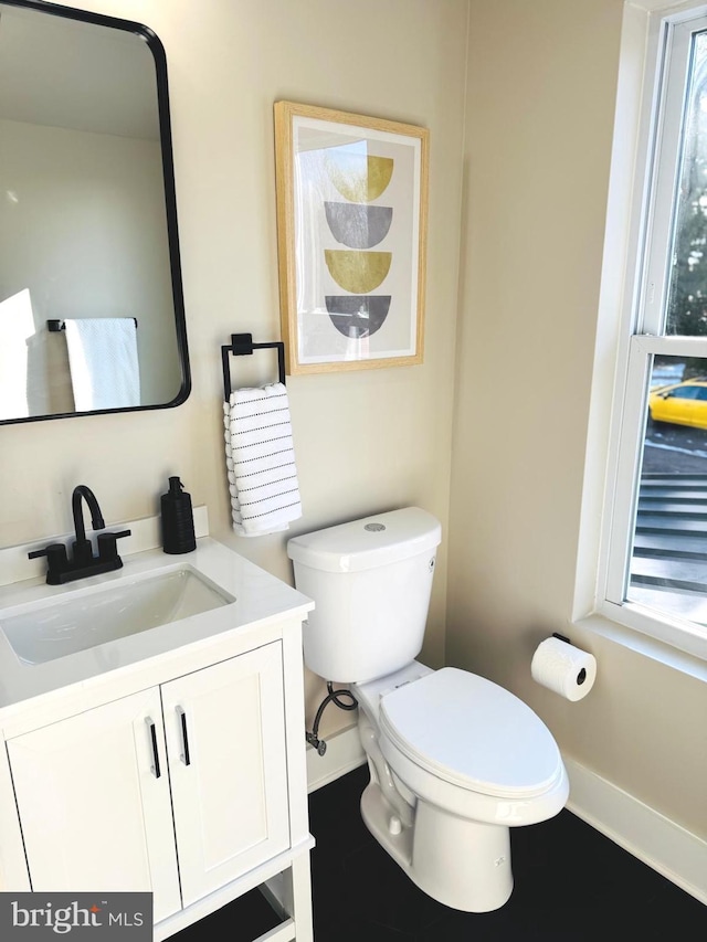 bathroom featuring vanity and toilet