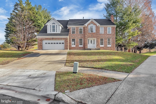 view of front of property with a front lawn and a garage