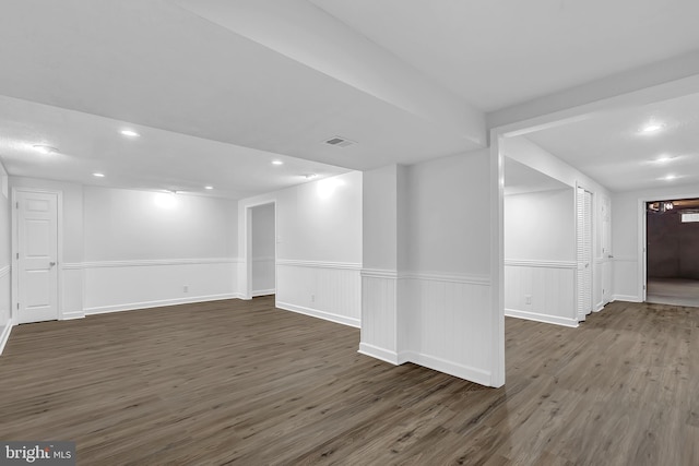 unfurnished room with dark wood-type flooring