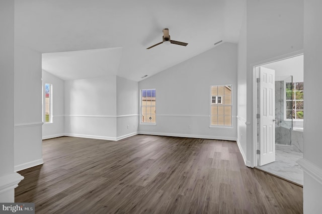 unfurnished living room featuring a healthy amount of sunlight and dark hardwood / wood-style flooring