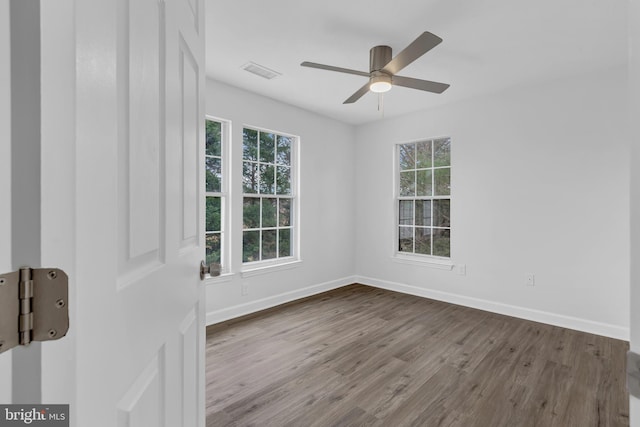 empty room featuring hardwood / wood-style floors, plenty of natural light, and ceiling fan