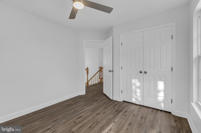 unfurnished bedroom with hardwood / wood-style flooring, a closet, and ceiling fan