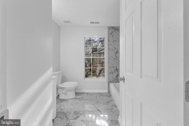 bathroom featuring toilet and a tub