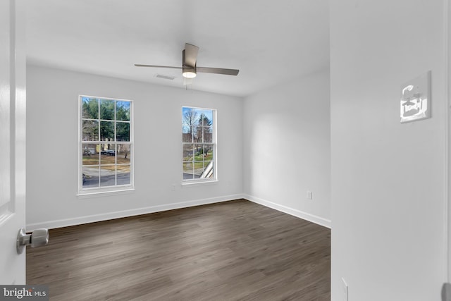 spare room with ceiling fan and dark wood-type flooring