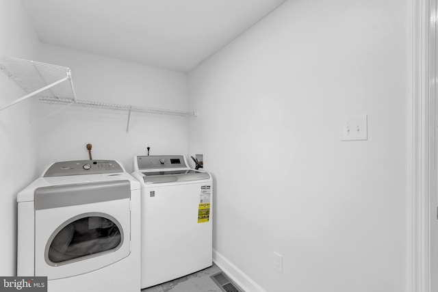 clothes washing area with separate washer and dryer