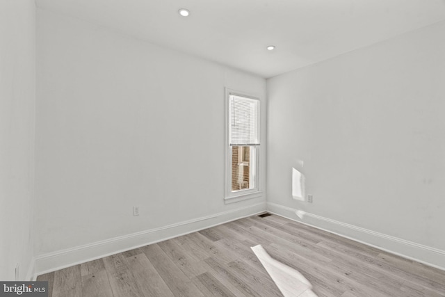 empty room with light hardwood / wood-style flooring