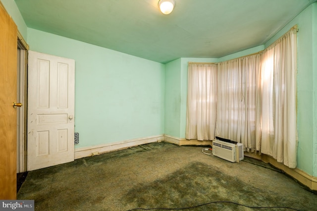 spare room featuring carpet and a wall mounted AC