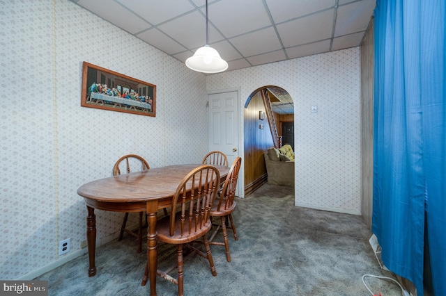 dining area featuring carpet and a drop ceiling